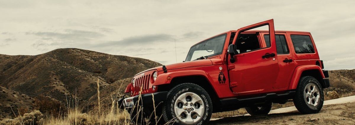 red-jeep-wrangler-going-down-a-dirt-hill-rocket-chip-plug-in-performance-chip