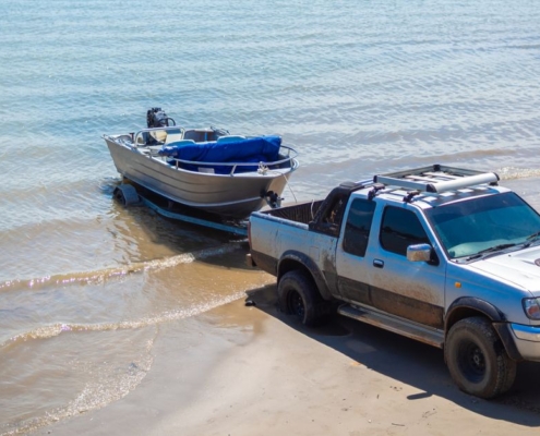 silver truck dropping boat into lake - rocket chip towing power