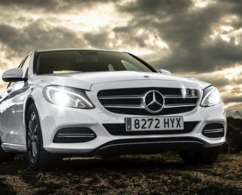 white-Mercedes-car-with-headlights-on - rocket chip - saving-gas-and-money
