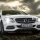 white-Mercedes-car-with-headlights-on - rocket chip - saving-gas-and-money