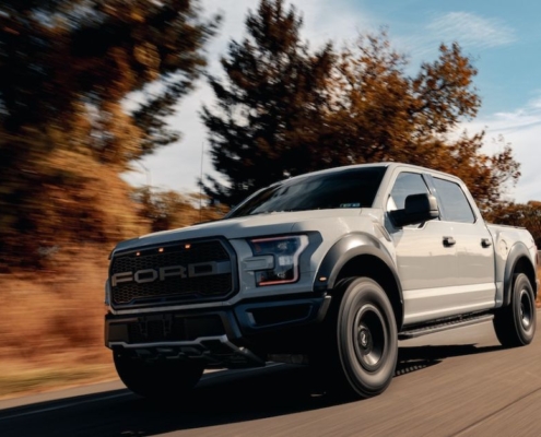 white Ford truck driving on a country road - rocket chip performance chips
