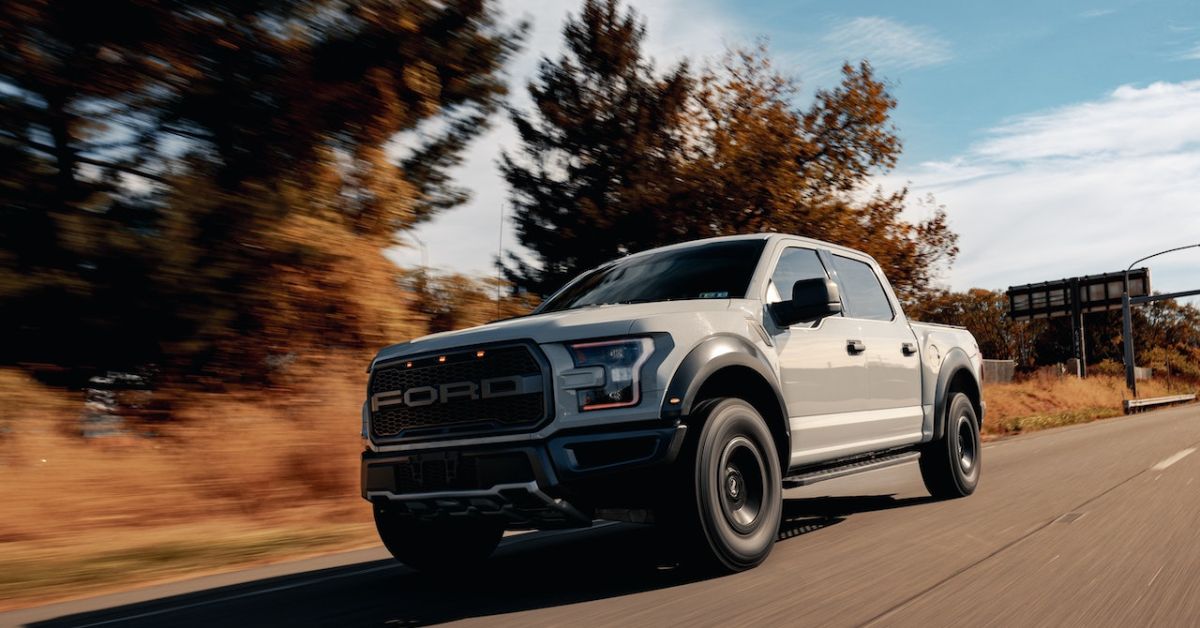 white Ford truck driving on a country road - rocket chip performance chip