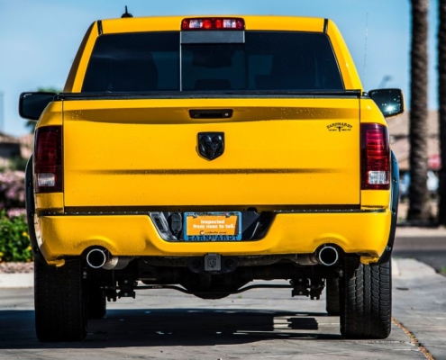 yellow dodge truck driving on a road - rocket chip plug in performance chips