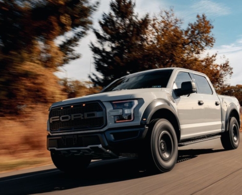 Grey Ford truck driving down a road - rocket chip Ford performance chip