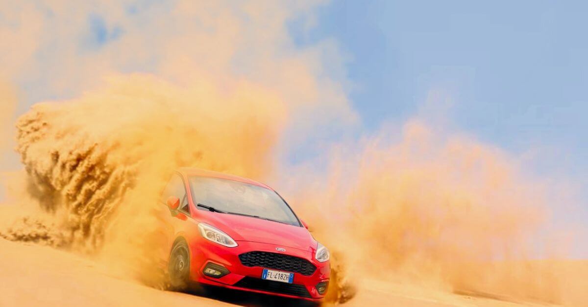 red Ford car driving through sand - rocket chip Ford performance chip