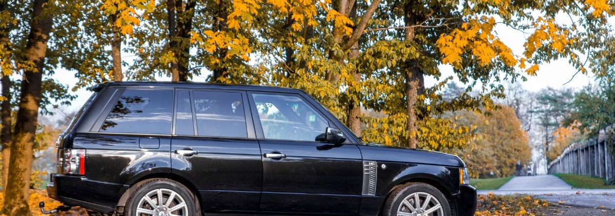 black Range Rover parked under tree in the fall time - rocket chip Land Rover Performance Tuning