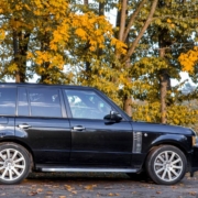 black Range Rover parked under tree in the fall time - rocket chip Land Rover Performance Tuning