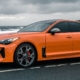 bright orange Kia car driving on gloomy day - rocket chip Performance Chips