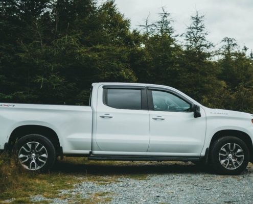 white Chevy Silverado parked near trees- rocket chip Chevy performance chips