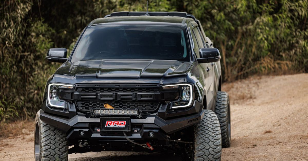 black Ford Raptor truck driving through dirt - rocket chip Ford performance chips
