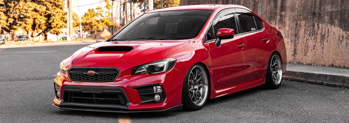 red Subaru hatchback parked in a lot - rocket chip Subaru performance chips