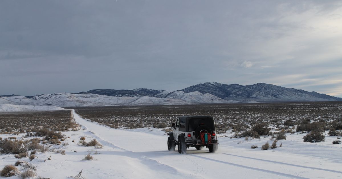 Jeep Wrangler driving through snow covered road - rocket chip Jeep performance chips