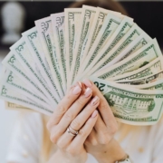 rocketchip-ECU-tuning-chip-071620241 woman holding up a fan of USD paper currency - rocket chip ECU tuning chip