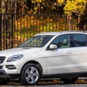 white Mercedes SUV parked near a black fence - rocket chip plug in performance chip