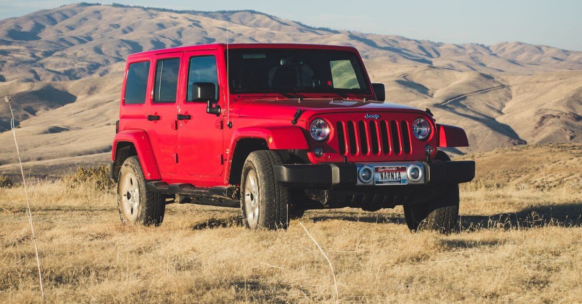 red Jeep Wrangler parked in grass - rocket chip plug in performance chip