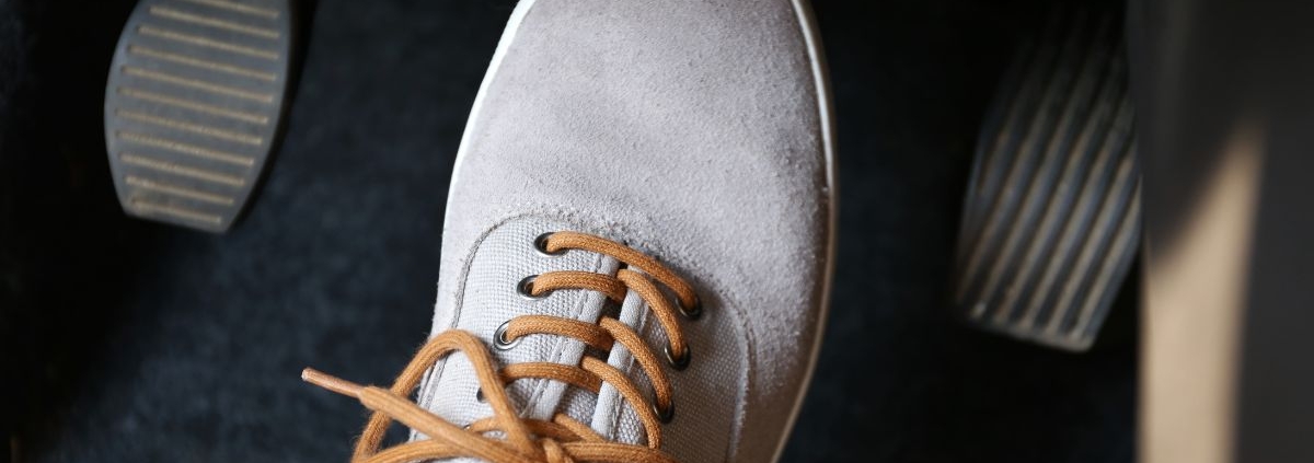 foot wearing a gray shoe pressing the gas pedal - rocket chip plug in performance chip