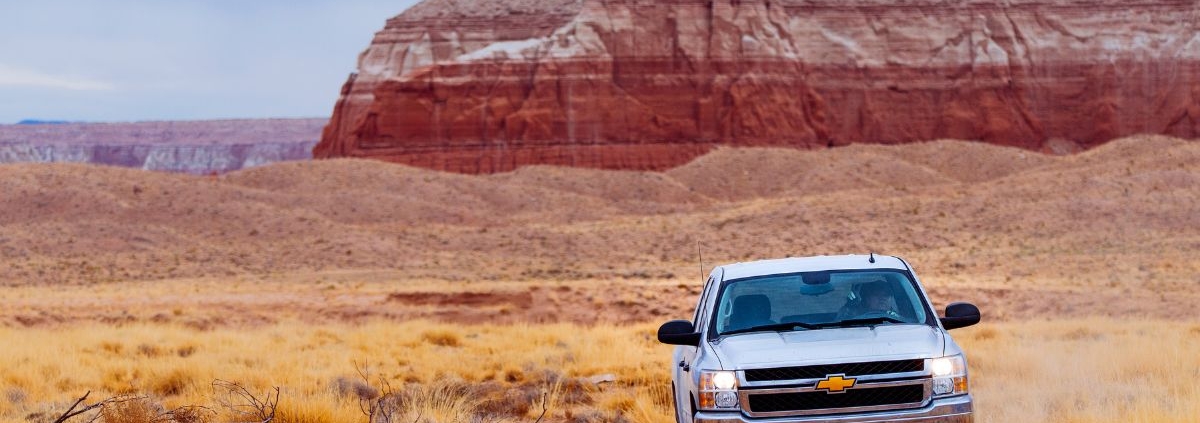Chevy truck driving through rocks in the dessert - rocket chip Chevy performance chip