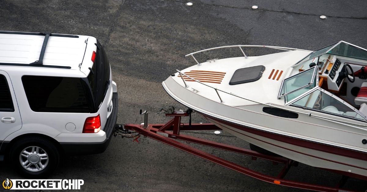 truck hauling a boat while driving on the highway - rocket chip increasing power for towing