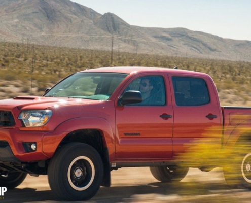 red Toyota truck driving through dirt road - rocket chip Toyota performance chips