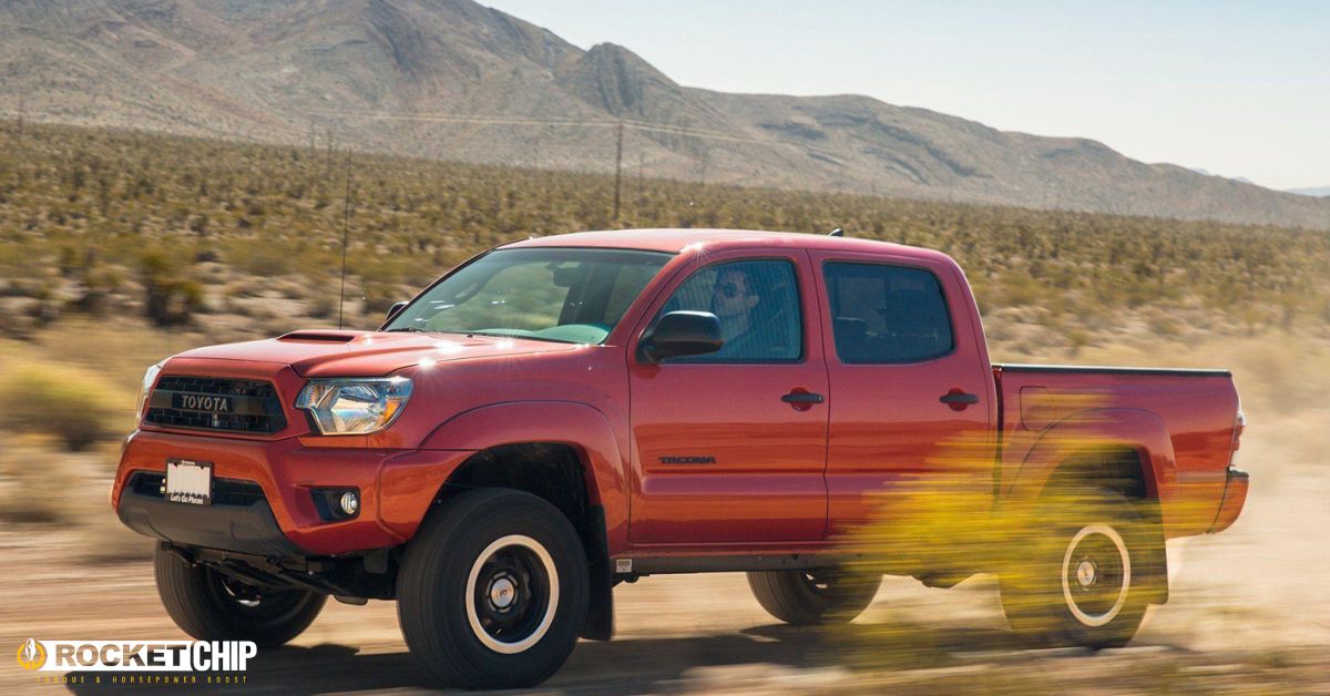 red Toyota truck driving through dirt road - rocket chip plug-in performance chips