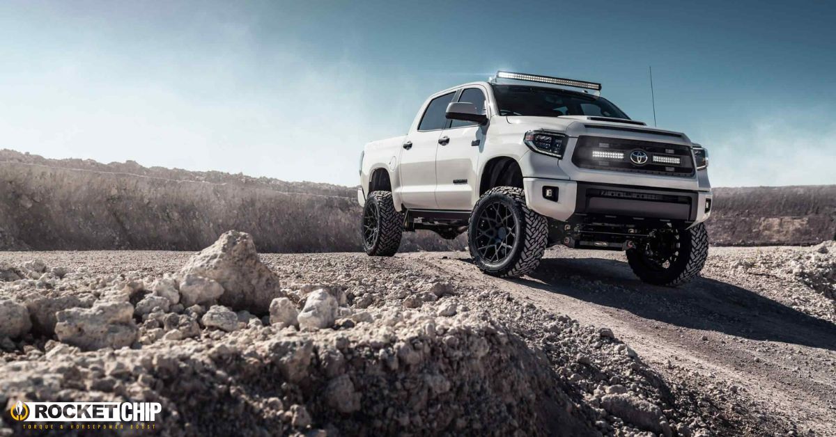 white Toyota truck driving through dirt road - rocket chip Toyota performance chips