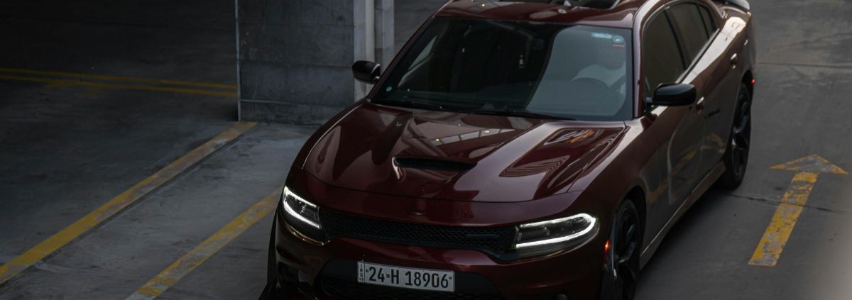 Maroon colored Dodge car driving down a road - rocket chip Dodge Performance Chips