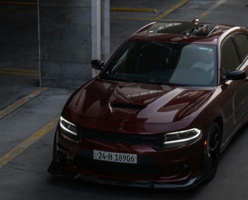 Maroon colored Dodge car driving down a road - rocket chip Dodge Performance Chips