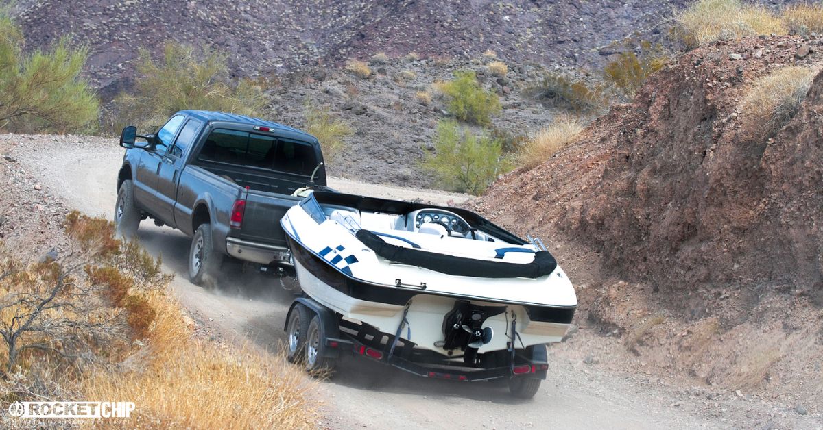 pickup truck hauling a boat up a hill - rocket chip Increasing Power for Towing