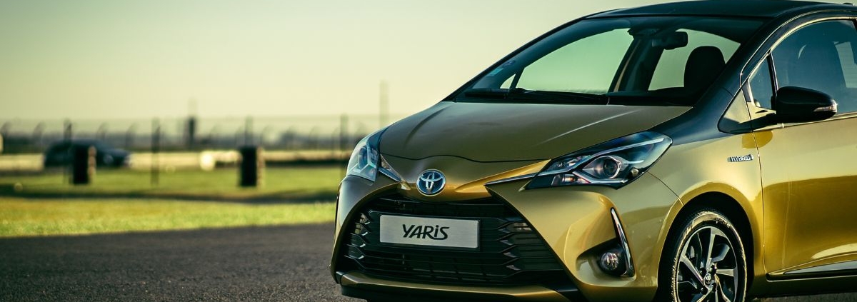 side view of a green Toyota Yaris - rocket chip improving MPG