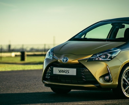 side view of a green Toyota Yaris - rocket chip improving MPG