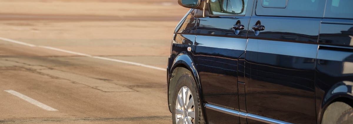 close up of a black mini van driving on a road - rocket chip improving MPG