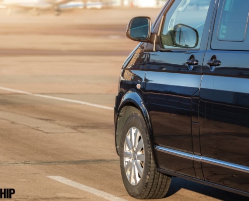 close up of a black mini van driving on a road - rocket chip improving MPG
