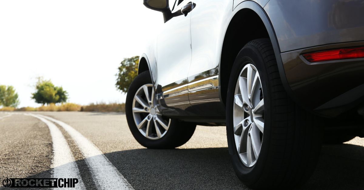 close up of tires on a white car - rocket chip improving MPG