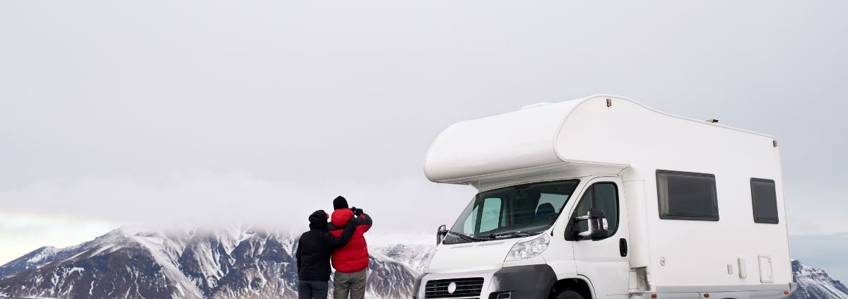 couple observing winter scene by their RV - rocket chip vehicle maintenance