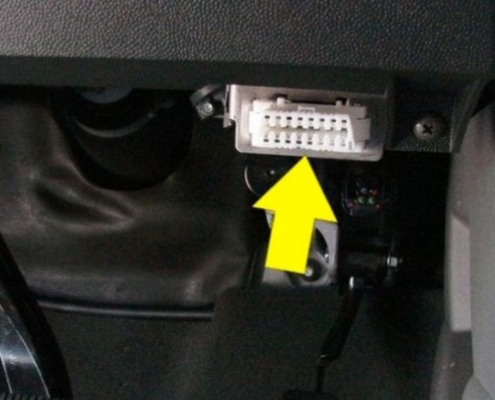 yellow arrow pointing to a vehicle OBD2 port - Rocket Chip performance chip